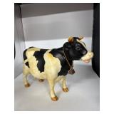 Black-and-White Cow Figurine With Bell