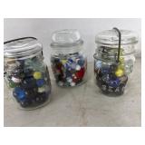 Three Glass Jars Filled With Assorted Marbles
