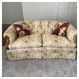 Floral Upholstered Loveseat with Carved Wood Arms