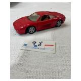 red diecast model of a Ferrari 348 1:24