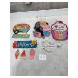 tropical-themed wooden hanging signs