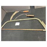 bow saw and 2 hand scythes