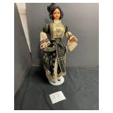 Greek costume porcelain doll with stand