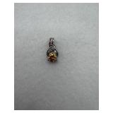 Sterling silver pendant with a yellow stone, and