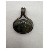 A sterling silver green stone oval pendant