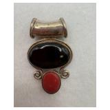 A sterling silver oval black stone and red stone