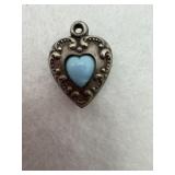 Sterling silver heart pendant with a small blue