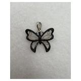 A butterfly pendant in sterling silver with black