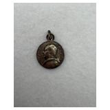 A sterling silver pendant of a pope