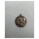 A sterling silver pendant of sacred heart of