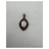 Sterling silver pendant with stones surrounding
