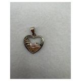 A sterling silver pendant with foot prints in the