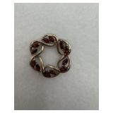 A sterling silver pendant with red stones