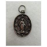 Sterling silver medal with detailed relief of the
