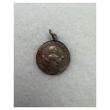 A vintage religious medal pendant made of