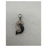 A sterling silver dolphin pendant with black and
