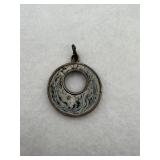 A donut shaped sterling silver pendant with a