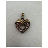 Sterling silver heart pendant features a ribbon