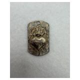 A sterling silver sacred heart dog tag charm