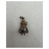 A sterling silver charm depicting a person in a