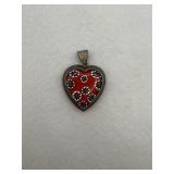A sterling silver with a red glass center piece