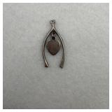 A sterling silver wishbone charm with a central