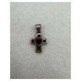 Sterling silver and a garnet heart cross pendant