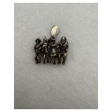 A sterling silver charm with the characters from