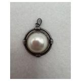 Sterling silver pendant appears to have a round