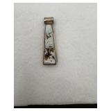 A Sterling Silver pendant appears to have an
