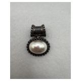 A vintage sterling silver pendant with a faux