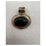 A vintage Mexican sterling silver pendant with a