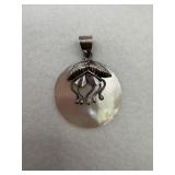 A sterling silver pendant of a mother pearl