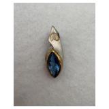 Sterling silver with a blue gemstone in a rhombus