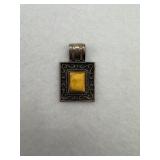 Sterling silver pendant with a yellow stone