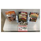 Three cookbooks and hand sanitizer, cow figurines