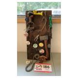 Collection board-tools, pins, tuba mouth piece,
