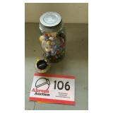 Jar of marbles and glass shaped baseball bank
