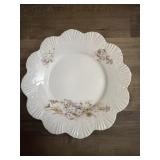 This vintage porcelain plate features delicate