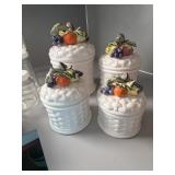 These vintage white ceramic canisters feature a