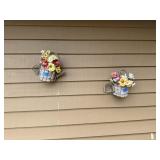 Two wooden wall decorations on back porch