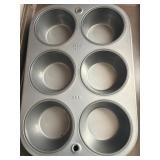 A cookie sheet and a muffin sheet