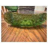This is a vintage green pressed glass canoe dish