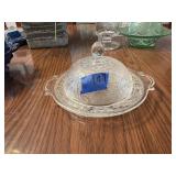This vintage clear glass butter dish features t
