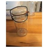 This vintage-style clear glass jar features a
