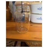 This vintage-style clear glass jar features a