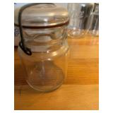 This vintage-style clear glass jar features a