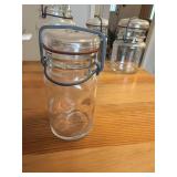This vintage-style clear glass jar features a