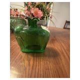 This is a vintage 1970s green glass bottle vase