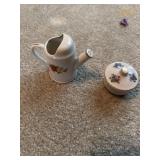 A little water pot and a candle holder with candle